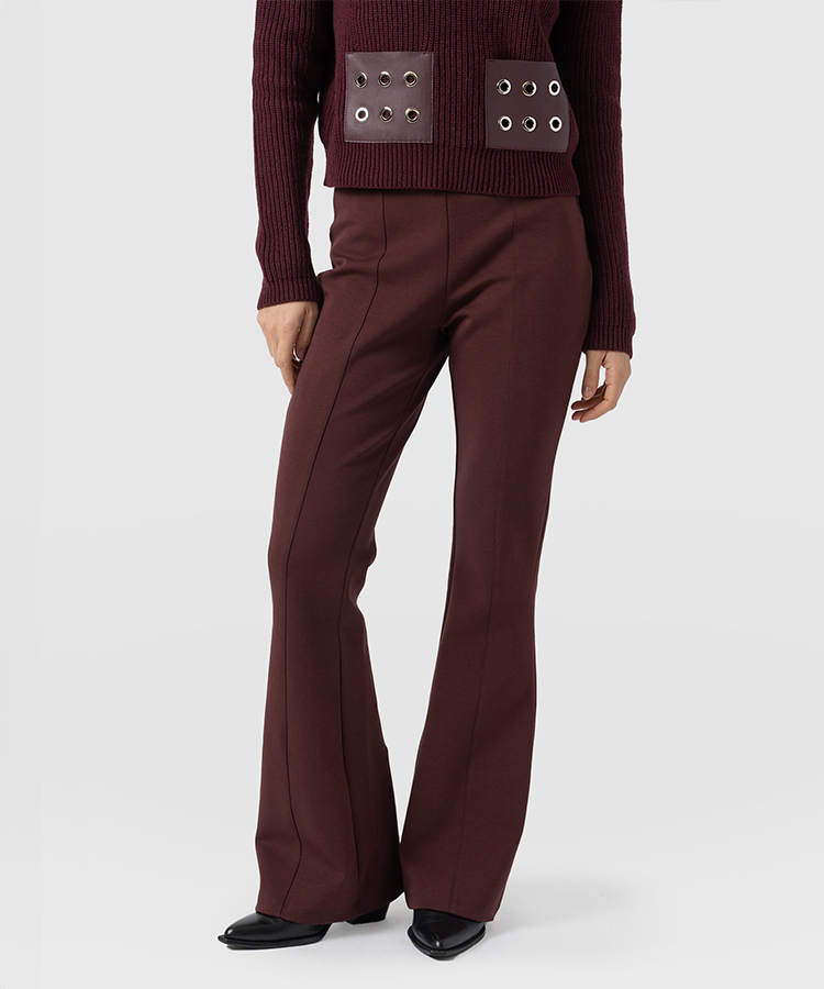 Flared-leg maroon trousers with pressed centre creases.