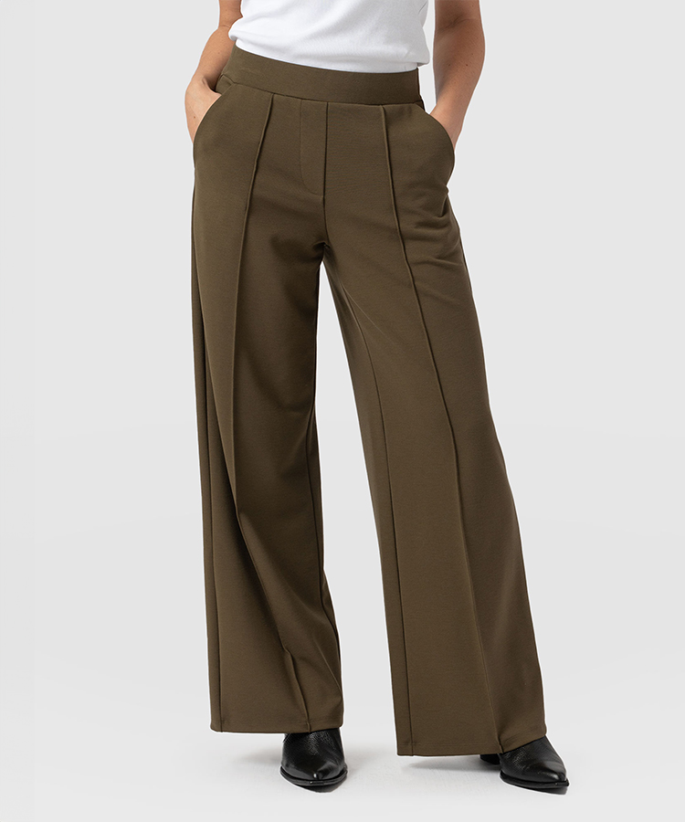 Green wide leg trousers in a jersey material with an elasticated waistband and pressed centre creases.