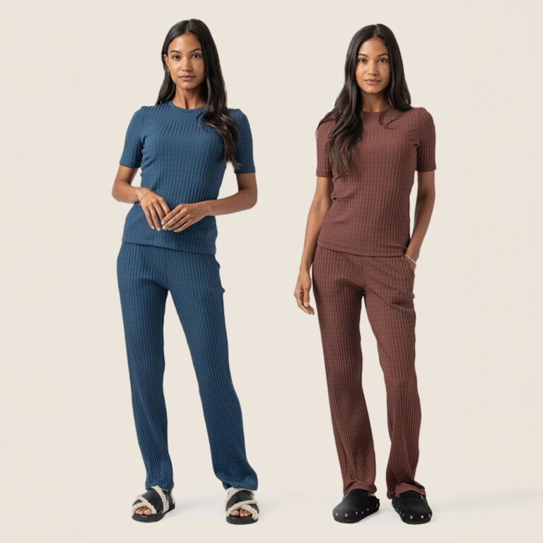 A woman wearing a compact knit maroon rib tshirt with matching trousers.