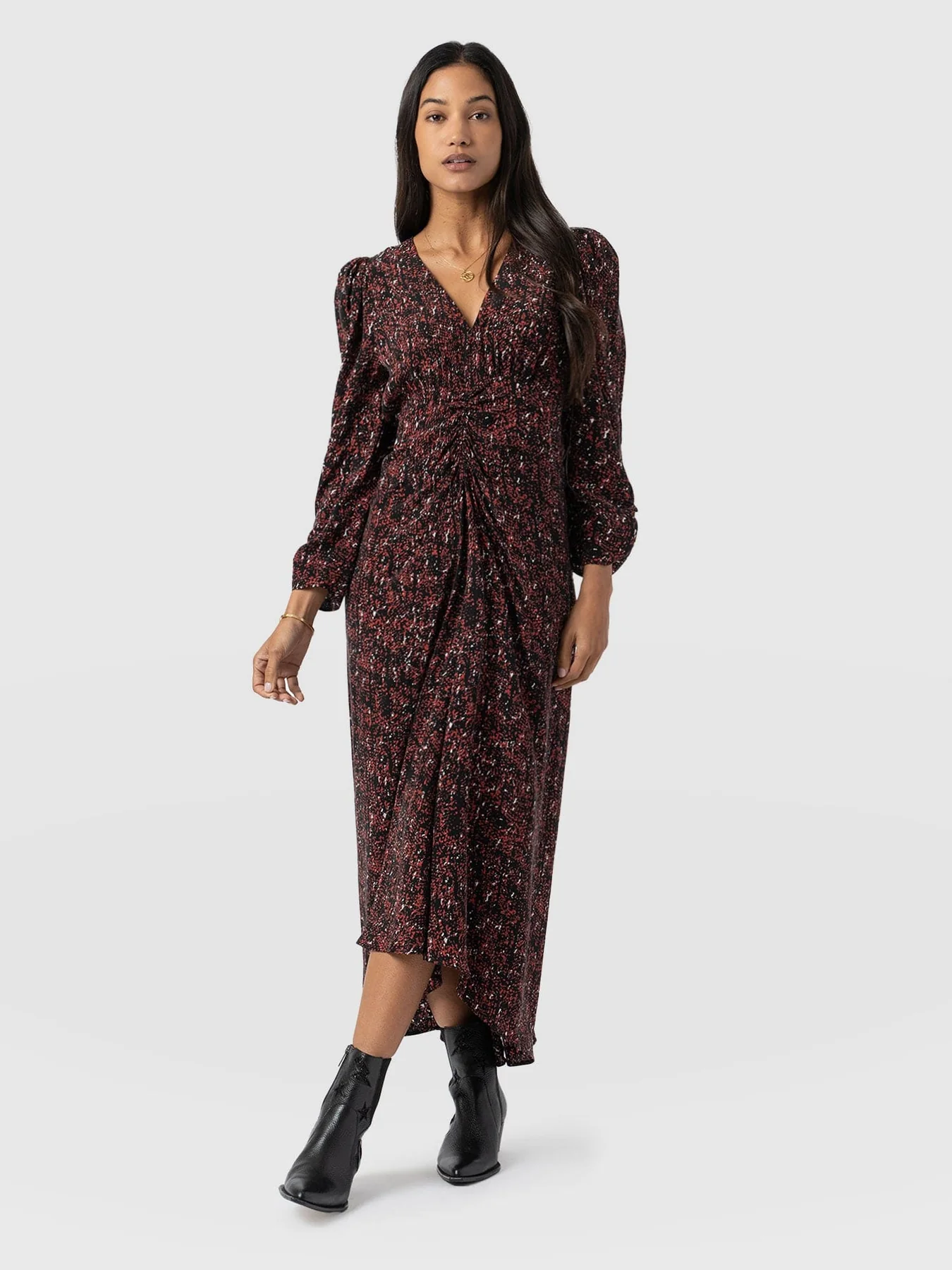 A model wearing Saint and Sofia's Paloma ruched long sleeve midi dress with the Billie Rock ankle boots.