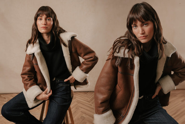 A model wearing a Saint and Sofia brown leather aviator jacket with cream shearling lining.
