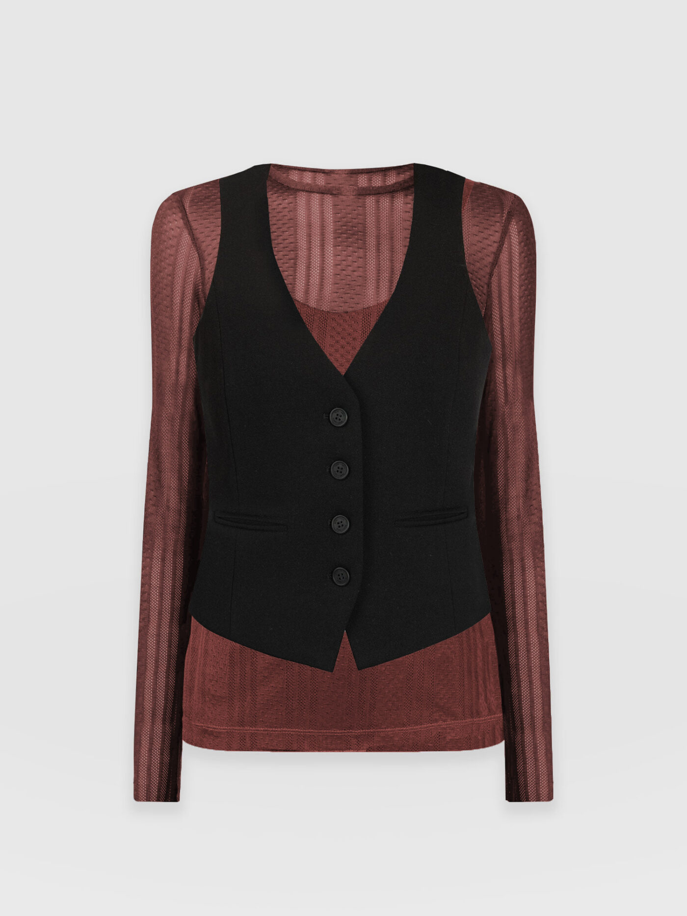 The Saint and Sofia Astrid Waistcoat in black layered over the Demi Lace Long Sleeve Tee in maroon. A semi-sheer striped tee with a crew neckline.