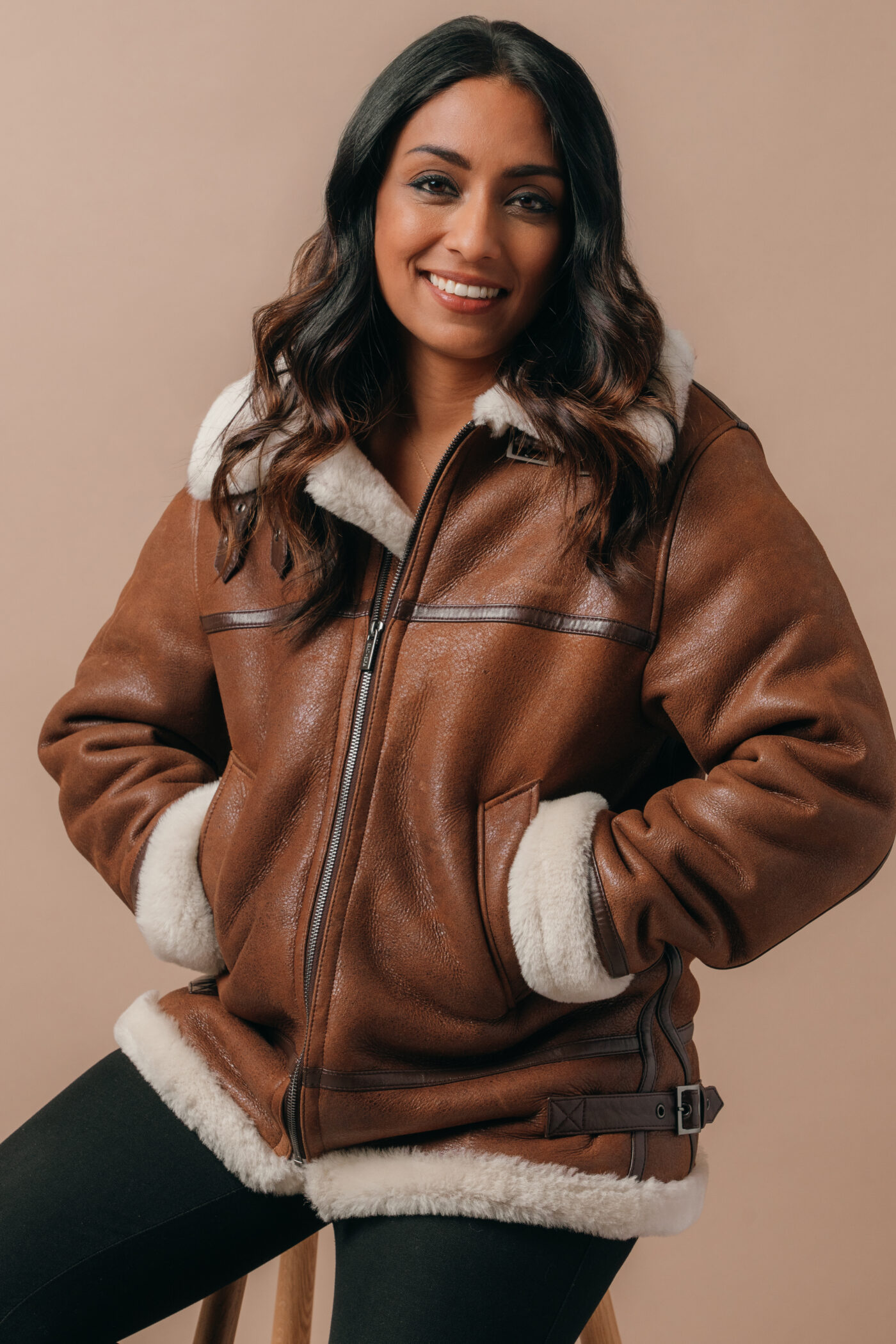 Isa Guha wearing the brown Amelia Aviator Jacket from Saint and Sofia