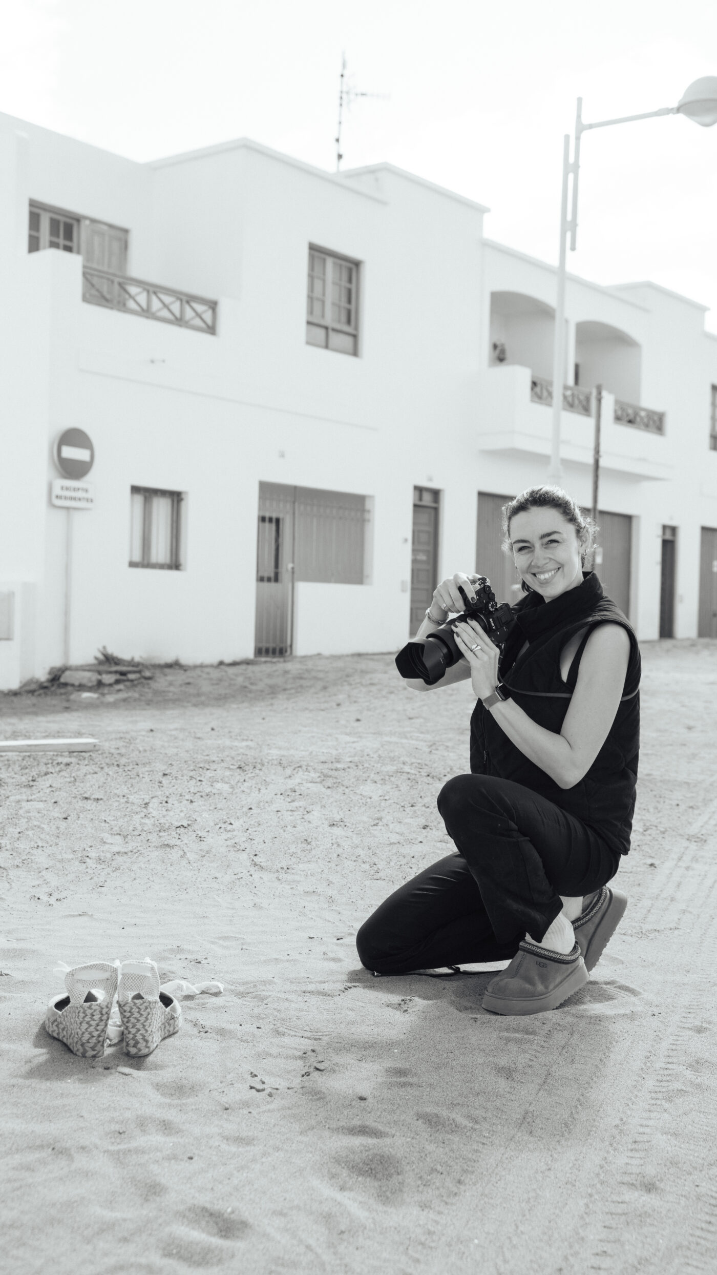 Our creative lead here at Saint and Sofia. Mika crouched in front of a building on location ready to shoot images.
