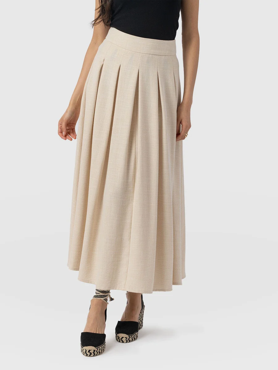 The saint and sofia eliza midi skirt. A cream linen effect design with a flat fronted waistband and pleated skirt.