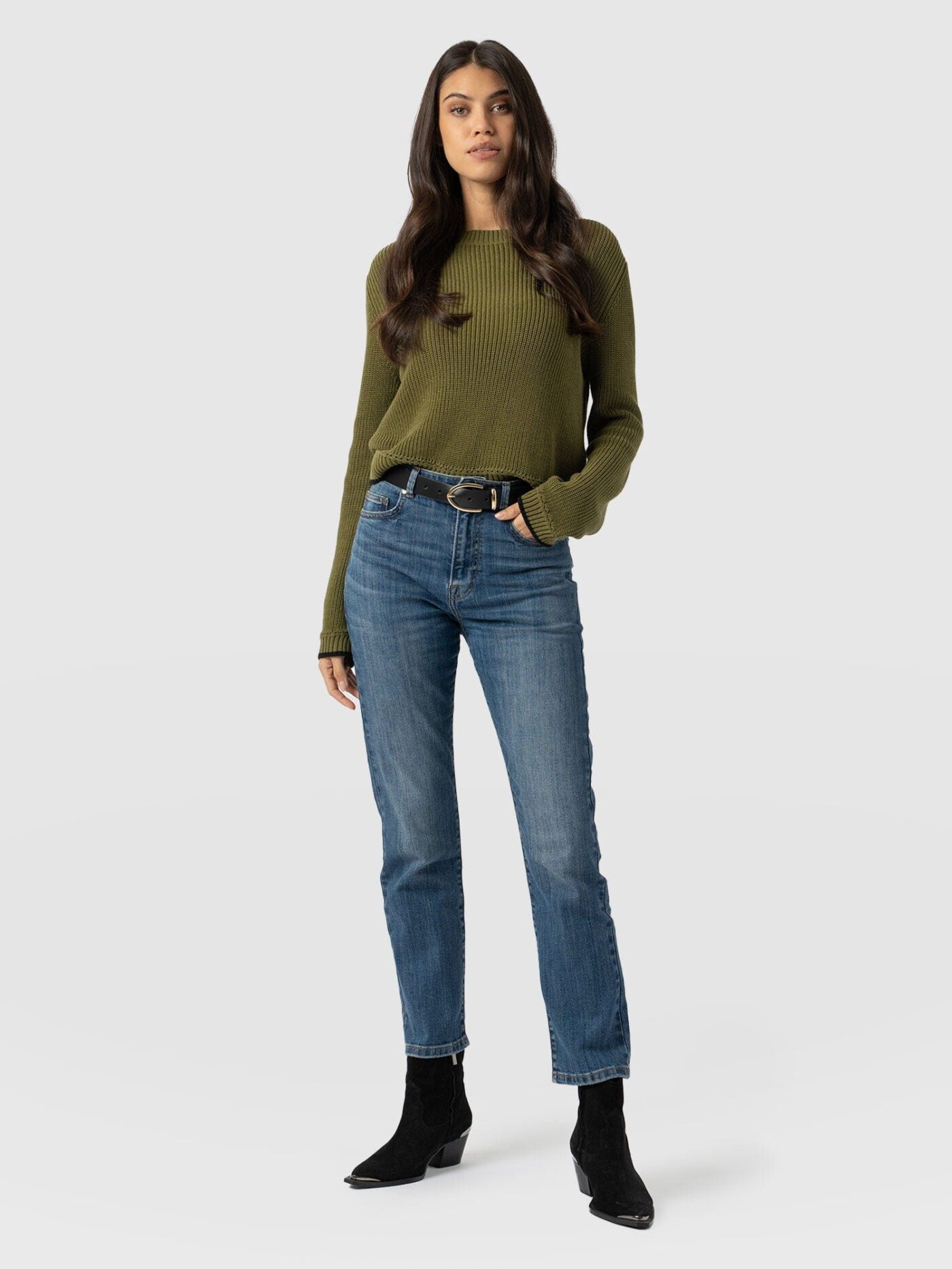 A model wearing a pair of Saint and Sofia Emma Straight Leg Jeans. This mid-rise pair help to balance the appearance of your torso and your legs to create more equal proportions. 