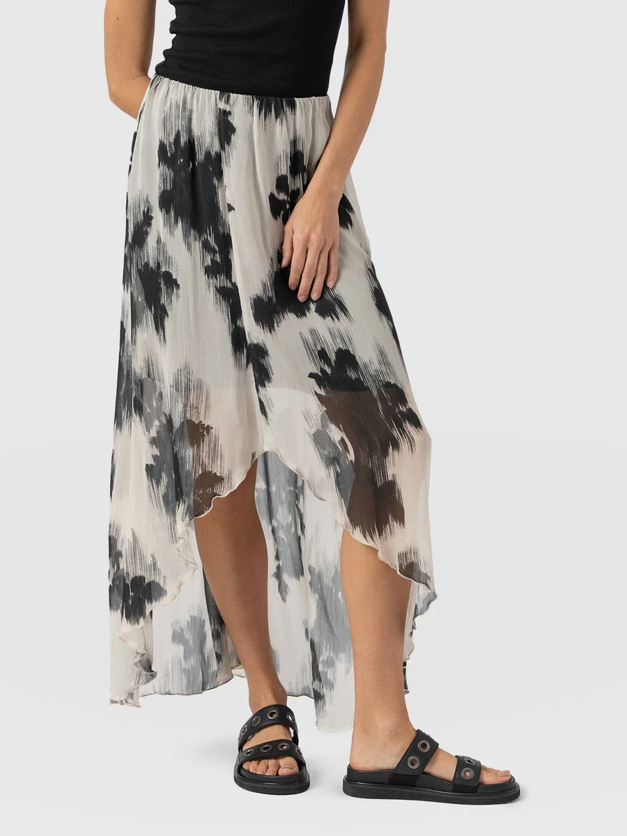 The Saint and Sofia Lexi High Low midi skirt. A black and white floral design made from a semi sheer georgette fabric.