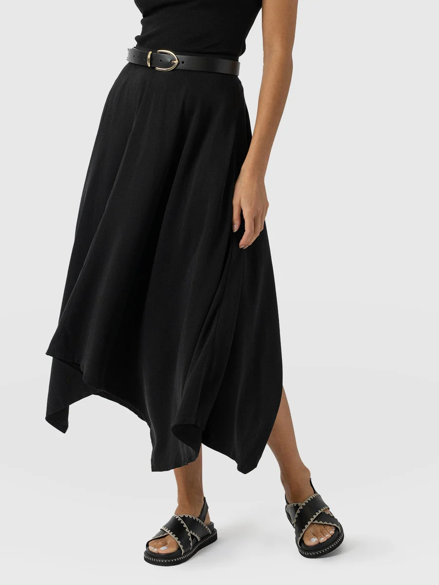 The Saint and Sofia Noho midi skirt. A black design with an asymmetric hem.