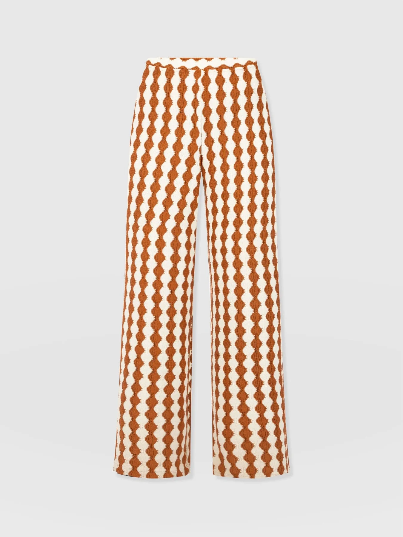 The Saint and Sofia Victory Wide Leg Trousers. A crochet-textured design in beige and brown with a high rise waist and wide leg fit. Perfect for summer.