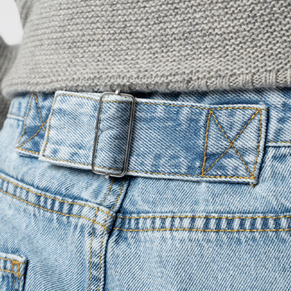 The adjustable buckle at the back of the Saint + Sofia Adjustable Jeans in blue denim