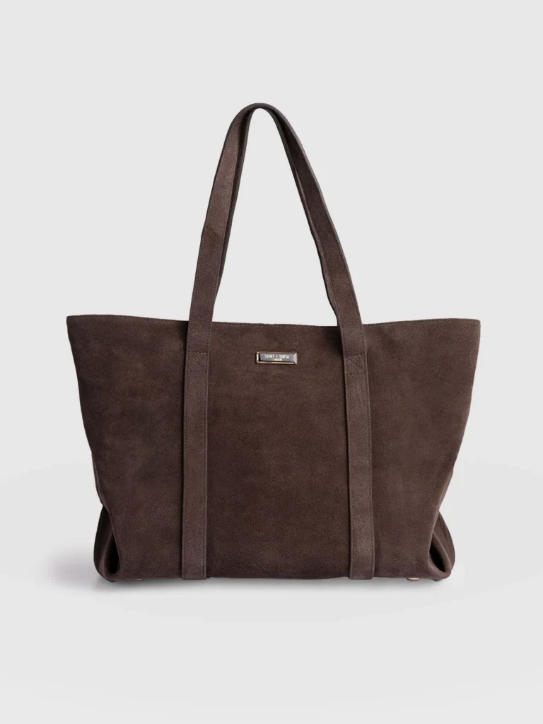 The Saint + Sofia Kara Shopper Bag. A brown suede design with double top handles and a brand plaque at the front.