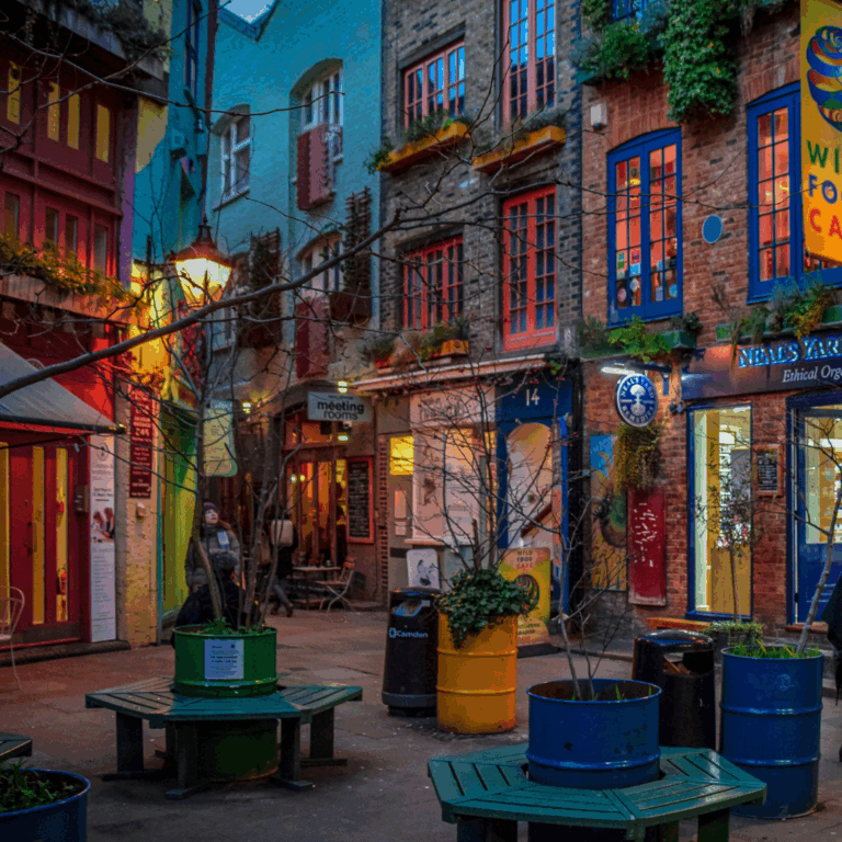 A picture of Neals Yard in Covent Garden at night. Beautiful coloured buildings in a square.