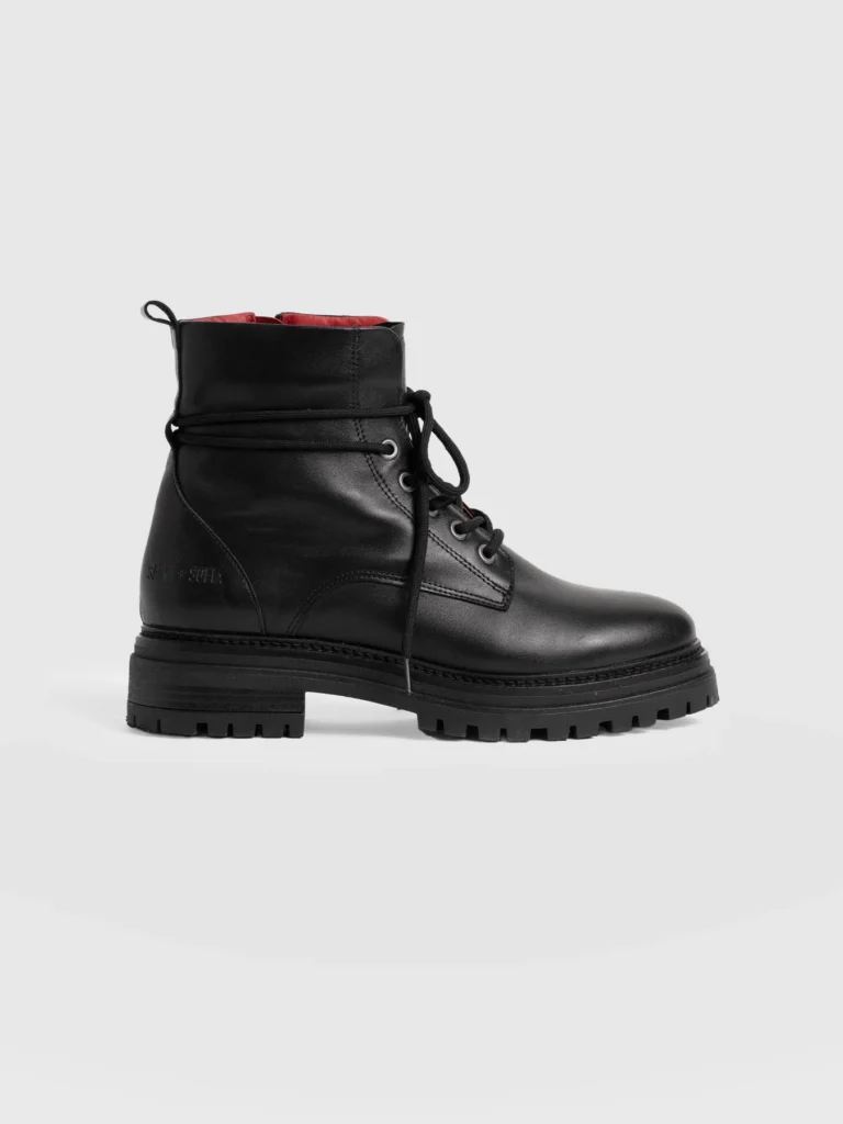 A black leather biker boot with a chunky tooth sole, lace-up fastening, and metal eyelets. From the Saint and Sofia October collection.