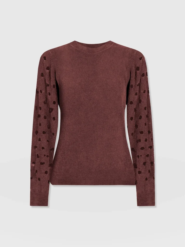 A crew neck knitted jumper with long sleeve decorated with key hole cut outs. In mauve. From the Saint and Sofia October Collection.