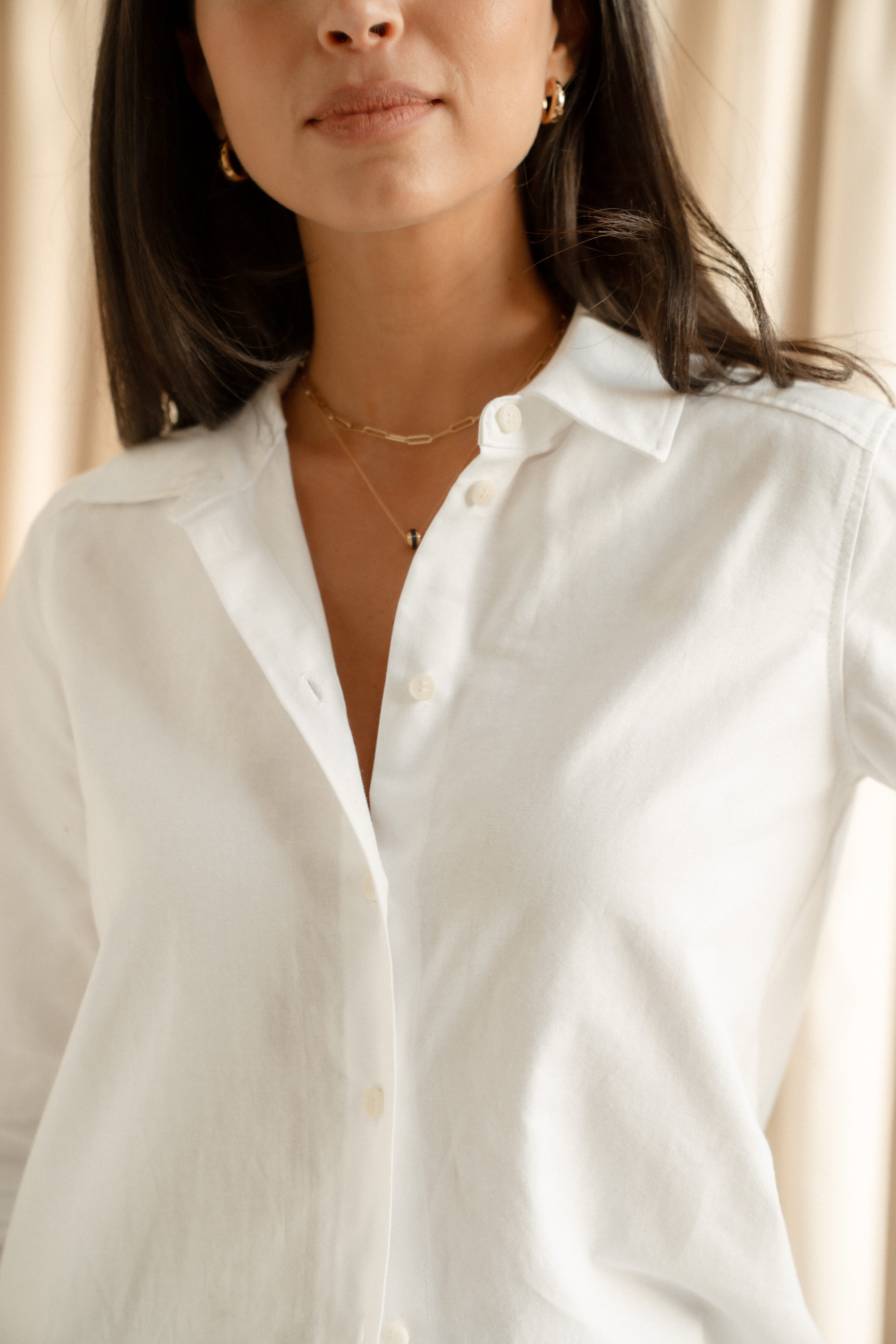 A close up shot of a model wearing a white shirt by Saint and Sofia