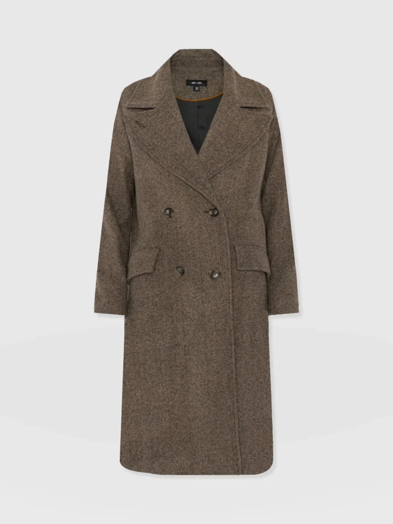 A double breasted wool trench coat with a wide collar and patch pockets at the side. From Saint and Sofia winter coats.