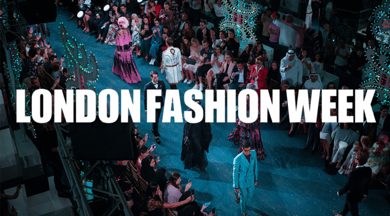An image of models walking down a blue catwalk wearing brightly coloured couture outfits. Across the top of the image is the text "LONDON FASHION WEEK" in white.
