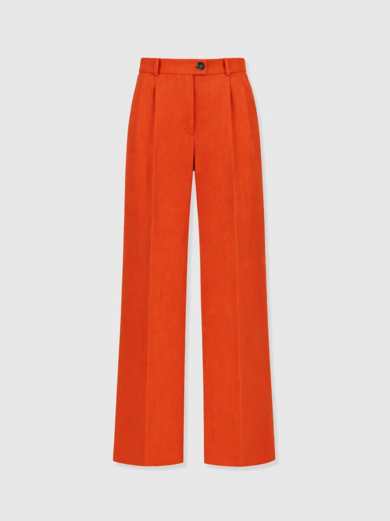 The Saint and Sofia Argent Wide Leg Trousers. Crepe trousers in Burnt Orange with a tailored buttoned waistband with belt loops and pleat detailing at the leg.