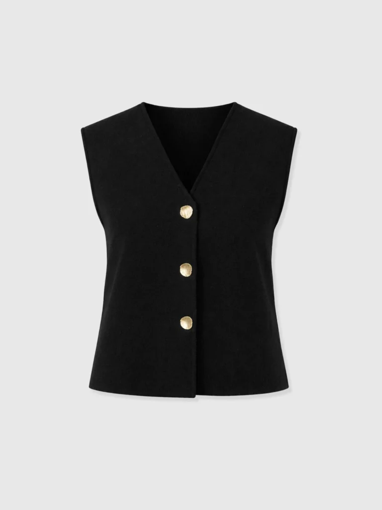 The Maeva Knit Waistcoat by Saint and Sofia. A V-neck button up knitted waistcoat with a relaxed fit and gold toned molten buttons.